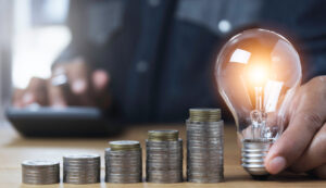 Hand of male holding a light bulb and copy space for accounting,